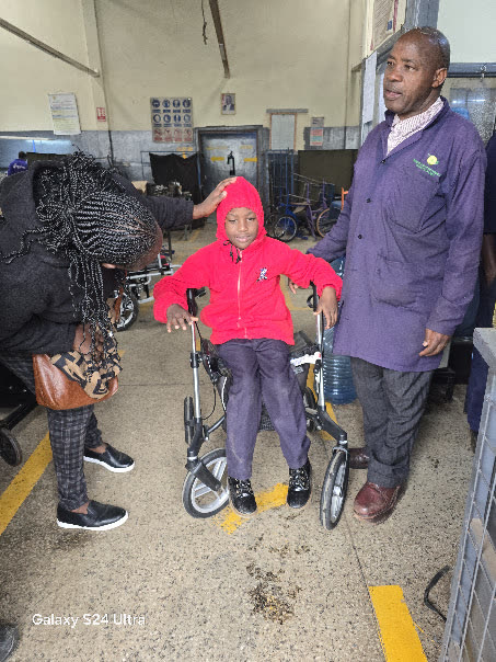 Ian testing the BHK outdoor-adapted rollator at APDK