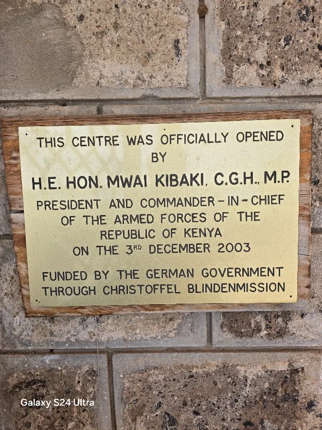 Plaque marking the official opening of the APDK centre in 2003